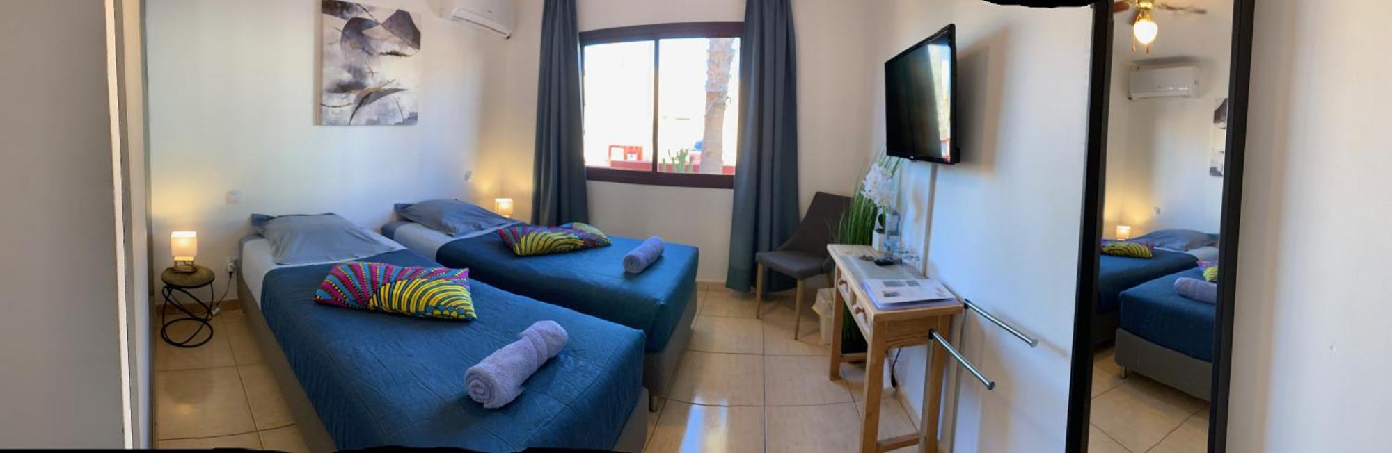 Bedroom With Shared Bathroom And Swimming Pool